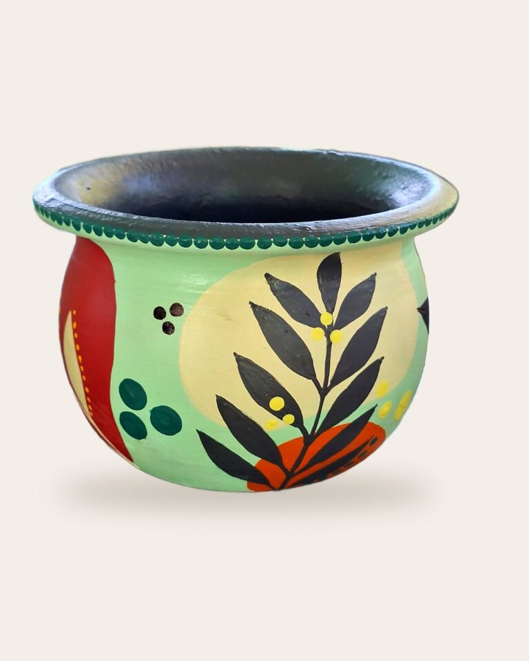 Vaso de concreto verde-menta pintado à mão com folhagem preta e laranja